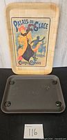 Front view of bamboo tray with poster print standing behind plastic footed tray