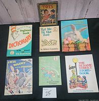Front covers of all seven books arranged for identification