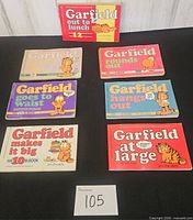 All seven Garfield books laid out face-up