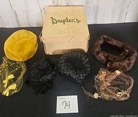 Group shot of five hats with Dryden’s box