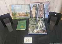 All four books and four metal bookends on display