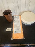 Overall lot: Tupperware pitcher, Magicloth package, Rubbermaid container