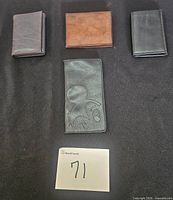 Four wallets laid out closed for size, color and style comparison