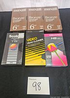 Front view of all sealed VHS tapes and head cleaner