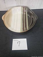 Top view of glazed stoneware pie plate showing handles and interior stripe pattern