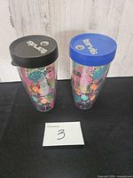 Two floral Tervis tumblers with blue and black lids
