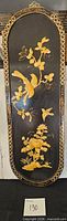 Full view of black lacquer wall panel with bird and flower inlay