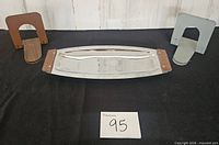 Full view of chrome tray centered between two metal bookends