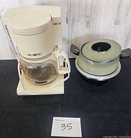 Front view of Mr. Coffee maker and fondue pot side by side