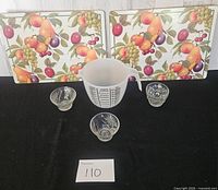 Overall lot showing placemats, measuring cup and three pressed glass bowls