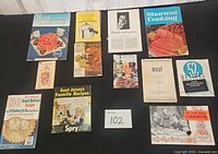 Overall view of all 11 cookbooks and pamphlets