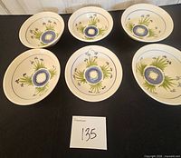 All six matching hand-painted pottery bowls displayed top view
