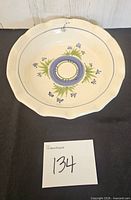 Top view of cream scalloped pie plate with floral design