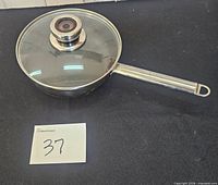 Top view of pan with lid on showing stainless exterior and handle