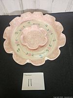 Top view of pink speckled ruffled chip and dip set showing platter and center bowl