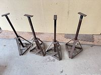Four tall jack stands lined up showing full form