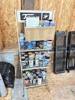 Full view of shelf with spray paint cans and box