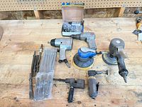 Overall shot of all pneumatic tools, chisels and boxed kit on bench