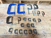 All clamps laid out on workbench showing quantity and size variety