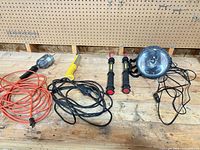 All five work lights laid out on bench