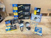 Overall lot showing stacked LED lights, winch, pump, cable lock, hooks and other items