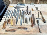 Full spread of assorted hand tools on workbench