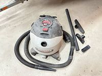 Vacuum with hose, wand and nozzle attachments