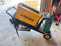Side view of Deca welder on cart with cylinder and leads