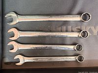 Four Mastercraft wrenches laid out showing both open and box ends