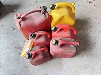 Front view showing all fuel cans and spout bag