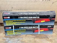Two GRIP 2-ton cross beam adapter boxes on workbench