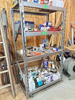 Full view of grey steel shelving unit with five shelf levels