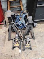 pile view of assorted jack stands showing quantity and general condition