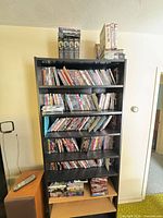 Five-shelf unit filled with numerous DVD cases