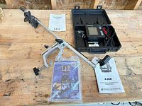 Overall lot showing fish finder in case, pole-mounted transducer, manuals and accessories