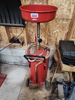 Full view of Lincoln oil receiver showing funnel, tank, wheels and handle