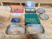 All items on workbench: Craftsman trays, dial caliper, magnetic catches box, drafting set, screwdriver set, round trays