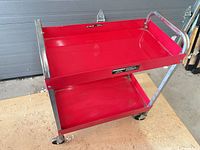 Full view of red two-shelf Powerbuilt cart on casters