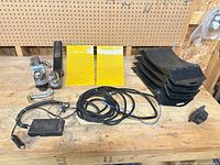 All items on workbench including ball mounts, coupler, wiring harness, leveling blocks, hitch cover, pins