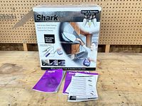 Front of box showing Shark Portable Steam Pocket and contents