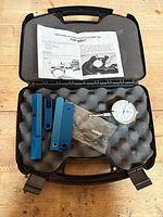 Open carry case showing dial indicator, blue bars, hardware pack and instructions