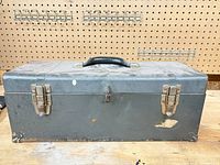 Closed grey metal toolbox front view