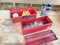 Two red toolboxes open with contents visible