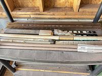 Multiple tubes and boxes of welding rods on shelf