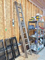 Full view of ladder leaning against wall