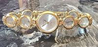 Front view of Anne Klein gold tone bracelet watch showing dial and crystal-filled links