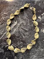 Full view of necklace laid flat showing bead shapes, colour and overall design