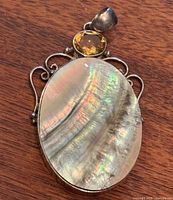 Front view showing mother of pearl cabochon and citrine accent