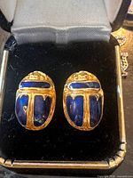 Front view of both earrings showing scarab design and blue enamel
