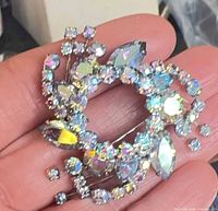 Front view of brooch showing stone arrangement and aurora borealis finish